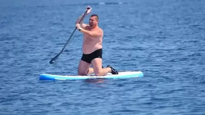 fat_guy_on_paddle_board